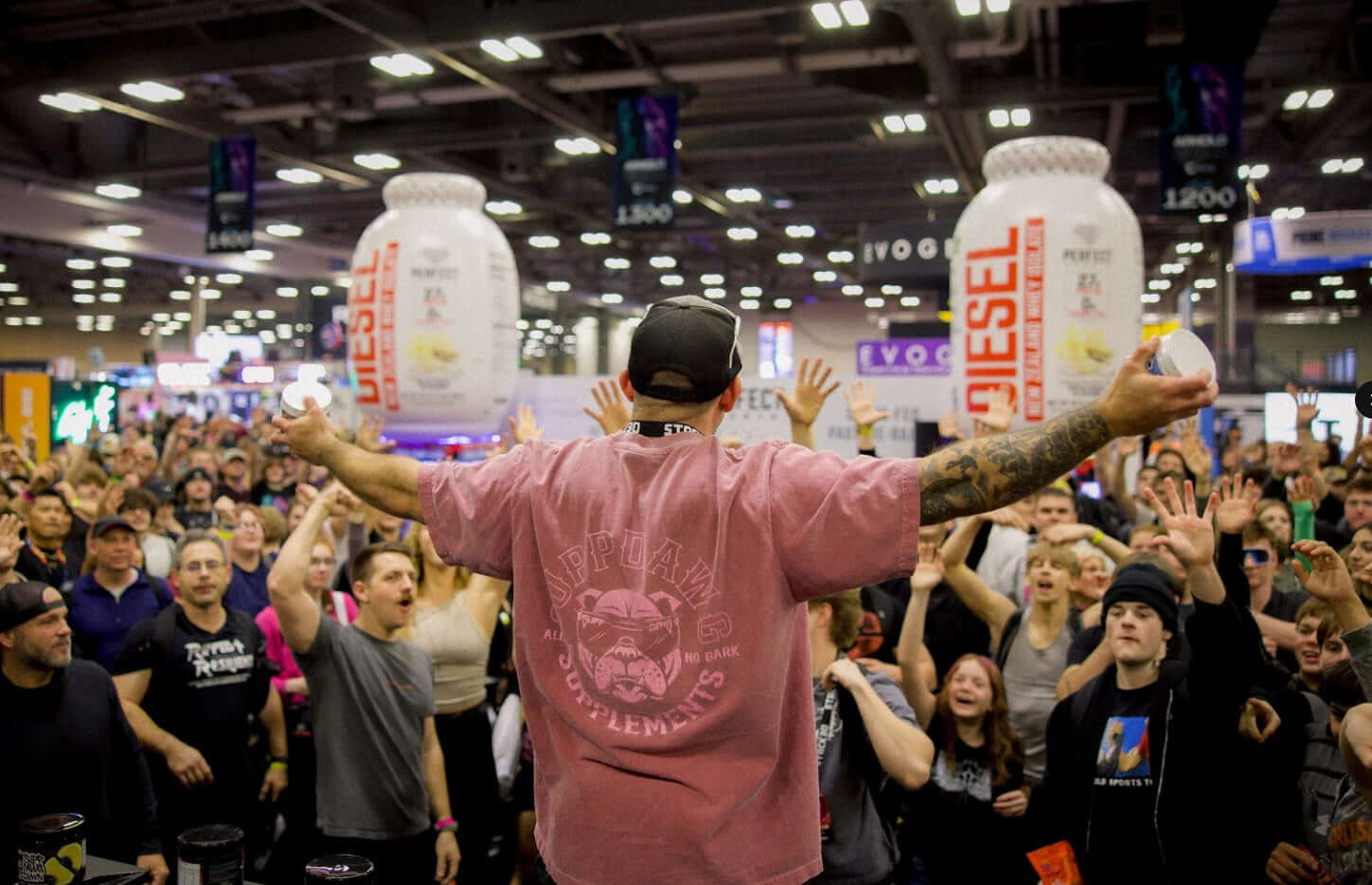 Supp Dawg representative interacting with large crowd at fitness expo