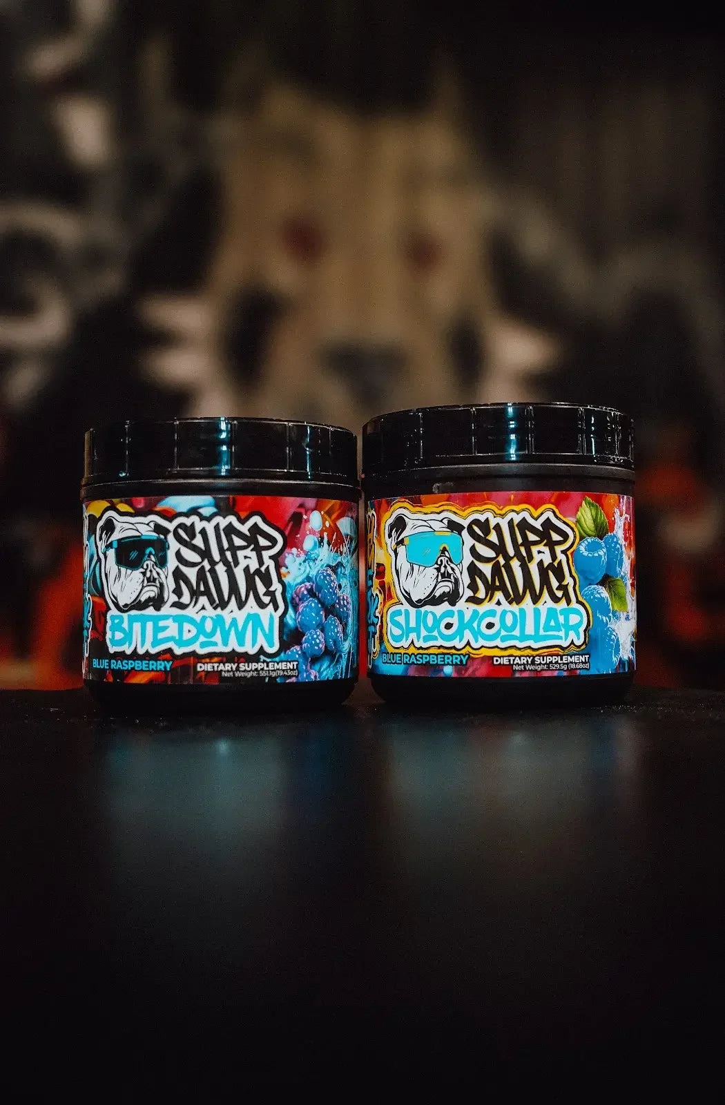 Blue Raspberry Bite Down and Shock Collar tubs with their front labels visible