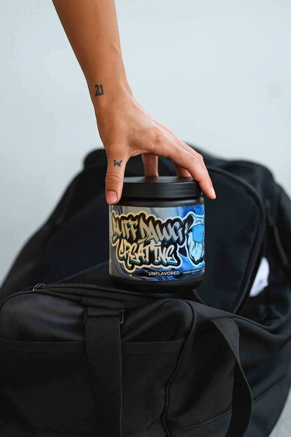 Buffdawg creatine placed on a black gym bag
