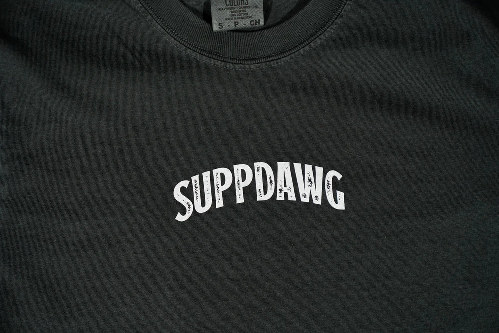 Close-up of the SuppDawg logo on a dark training shirt