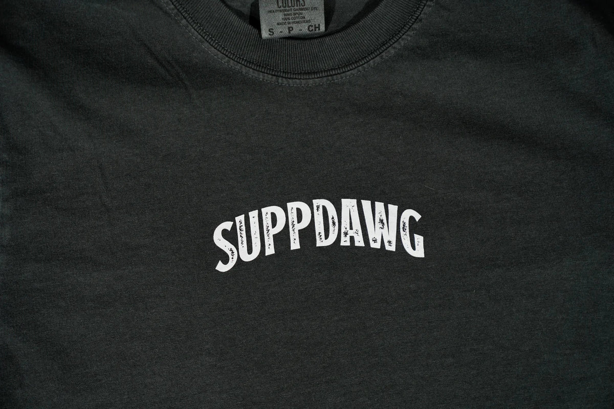 Close-up of the SuppDawg logo on a dark training shirt