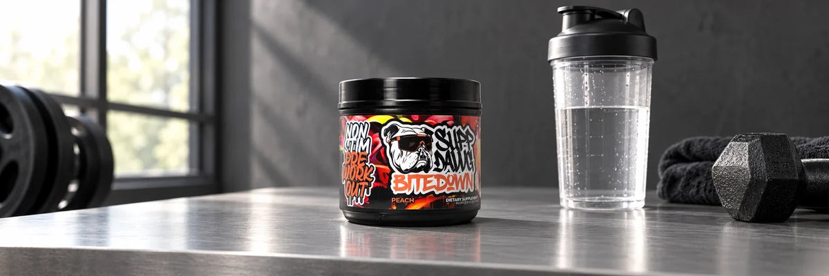 Bite Down Peach tub beside a clear shaker on a gym counter.
