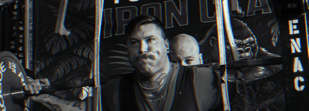 SuppDawg strength athlete bracing under the squat bar with spotters