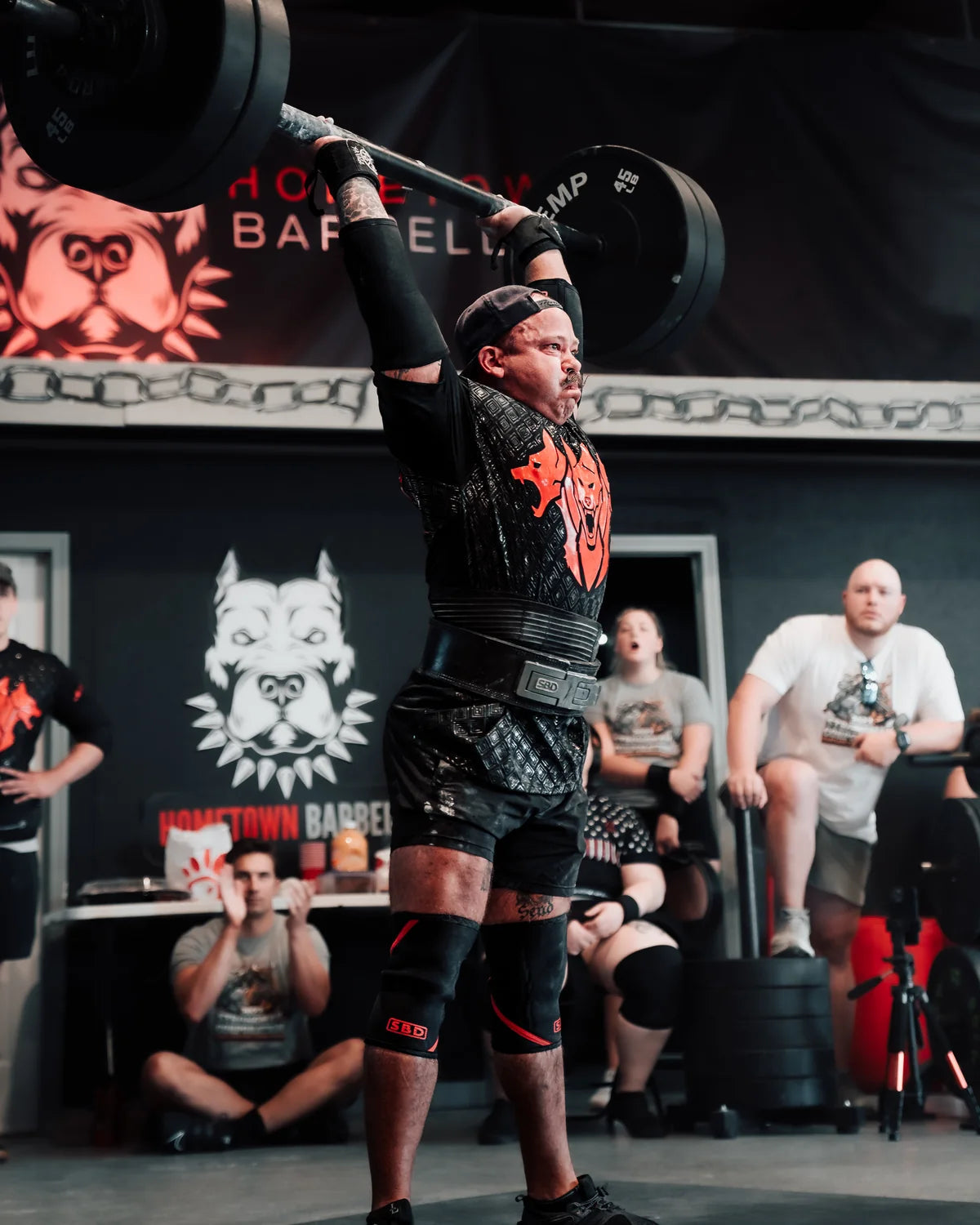 SuppDawg founder Chris Northern overhead pressing at a strength competition