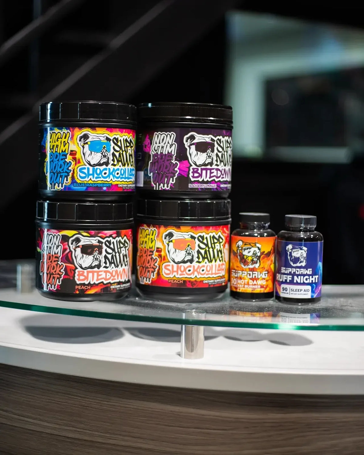 SuppDawg pre-workout and capsule products arranged on a display