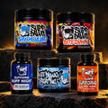 AI-assisted Whole Dawg campaign composition: one each Shock Collar, Bite Down, Buffdawg creatine, Ruff Night and Hot Dawg. Example flavors shown; refer to authentic individual product labels.
